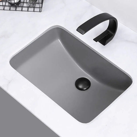 Straight Up Heavy Duty Ceramic Sink, Square Under Counter Wash Basin, Solid Gray Pedestal Sink with black faucet on marble countertop.