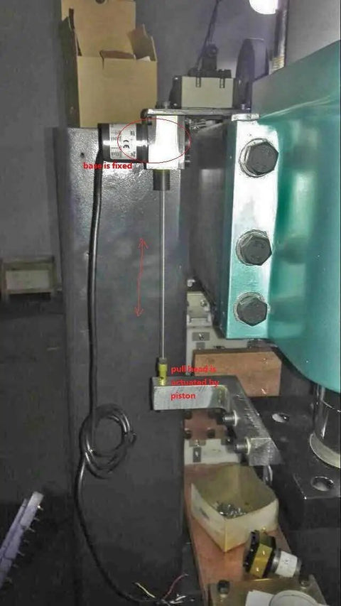 1000mm Draw Wire Encoder with 24V DC supply and 0-10V output installed in factory automation machinery