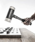 Dead Blow Mallet With Non-Rebounding Action, 60mm Head, 3.9 Lb Weight in hand beside metal workbench and fittings