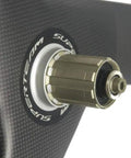 Close-up of Carbon Fiber 56mm Clincher Wheel TriSpoke Wheelset For Road Bike With 3K Matte Finish, showing Novatec hub attachment point.
