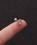 12 Pairs CZ Stud Earrings 16G Cartilage Earring Set For Tragus Helix And Ear Piercings, Hypoallergenic 316L Stainless Steel With Clear Cubic Zirconia, Tiny Ball Screw Back Earrings, Cute Heart And Flower Designs For Women. Heart CZ cartilage stud earring on finger, 316L stainless steel, 16G