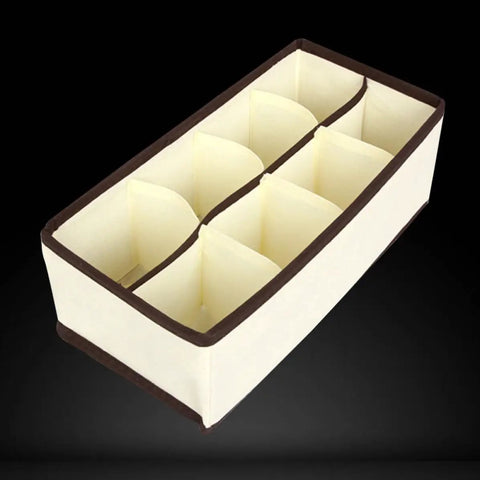 Top Tier Setup For Messy Drawers This Foldable Beige Drawer Organizer with Eight Generous Compartments for Socks and Underwear.