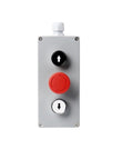 Metal push-button control box front panel with black up-arrow button, red emergency/start dial, and white down-arrow button.