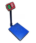 Heavy Duty Foldable Digital Floor Scale Delivering Straight Shooter Accuracy HD LCD Display And No Hassle Rechargeable Power For Luggage And Parcel Weighing Up To Six Sixty Pounds on a blue diamond plate base.
