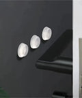 Bulk 1000 Pack Silicone No Slip Pads For Drawers And Cabinets on a cabinet door, soft rubber feet in 10x2mm size shown.