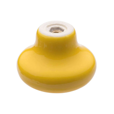 Close-up of a round bright yellow ceramic kitchen cabinet knob, part of the Six Piece Set Of Round Ceramic Kitchen Cabinet Knobs In Bright Yellow Make Totally Cute Furniture Drawer Pulls And Dreamy Cupboard Handles To Freshen Up Your Living Space Today.