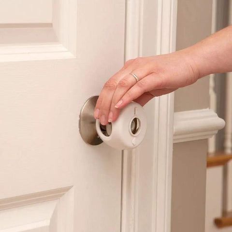 Hand installing Grip N Twist cover from Home Safety Essentials Kit For Kids With 46 Pieces Including Door Knob Covers And Cabinet Latches White Finish