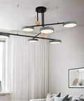 Sleek Modern 6 Head Sputnik Chandelier With Smooth 360 Degree Rotating Gold Pendant Light Top Notch Ceiling Fixture For Dining Room Bedroom Kitchen Setup Featuring Vintage Edison Socket suspended over a modern living room.