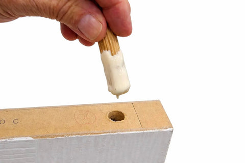 Hand inserting fluted birch dowel pin with glue into board for joinery, part of Birch Dowel Pins 1/4 In x 1-1/8 In 200-Pack.