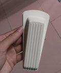 White Door Wedge Stopper from 5 Pack Rubber Non Skid Wedge Shaped Door Stoppers for Floor Protection in hand