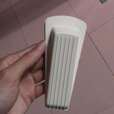 White Door Wedge Stopper from 5 Pack Rubber Non Skid Wedge Shaped Door Stoppers for Floor Protection in hand