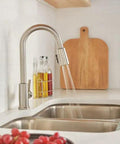Kitchen scene with Flute Pull-Down Kitchen Faucet With POWERINSE Technology, 3-Function Spray, high arc gooseneck, stainless finish.