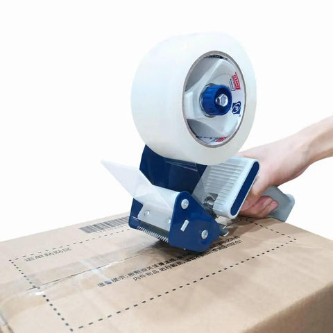 Pro Grade Heavy Duty Packing Tape Set With Tape Gun sealing a cardboard box, showing tape roll and blue dispenser in use.