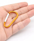 Hand holding single orange 1.8 Inch Aluminum Carabiner from Set 32 Pack With Spring Loaded Gate D Ring Clips 8 Color Assortment Plus 32 Steel Rings