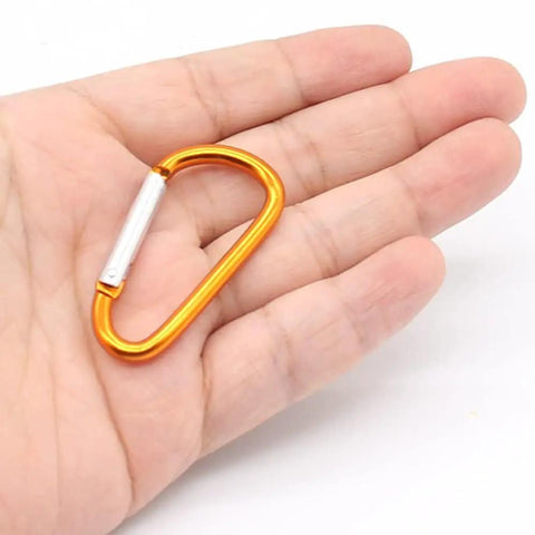 Hand holding single orange 1.8 Inch Aluminum Carabiner from Set 32 Pack With Spring Loaded Gate D Ring Clips 8 Color Assortment Plus 32 Steel Rings