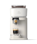 Compact Home Espresso Machine With Built In Grinder And 16 Bar Pump auto grinding tamping and brewing for smooth bean to cup coffee. White design.