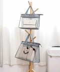 Clear Dustproof Handbag Storage Organizer For Closet with pouches hanging on wooden stand, showcasing medium to large bags.