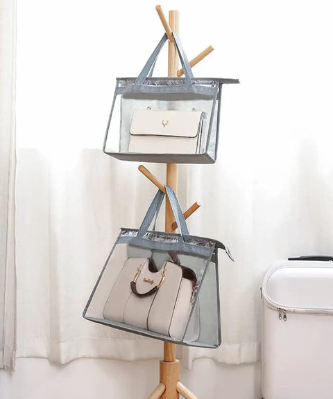 Clear Dustproof Handbag Storage Organizer For Closet with pouches hanging on wooden stand, showcasing medium to large bags.