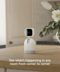 Smooth Swiveling Indoor Security Camera Locks Down Your Space With Crisp HD Video And Infrared Night Vision For Seamless Pan Tilt Coverage Plus Quick Plug And Play Two Way Audio Alexa Ready White on a wooden table.