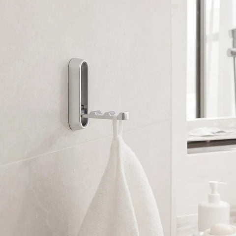 Sleek Black Folding Wall Hooks Four Pack With Swivel Hinge Design Perfect For Tight Spaces And Narrow Hallways No Hassle Kickback Mount holding a towel.