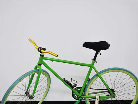 Gold Mountain Bike Riser Bar 31.8mm Clamp 440mm Length For Kids on a green bicycle with blue tires.