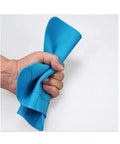 Hand holding a flexible blue mat, showcasing the durability of the Two Pack Silicone Soldering Mat For Electronics Repair Workstation.