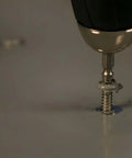 Close-up of Pro Grabit 8430P Two Step Drill Bit And Screw Extractor Kit removing stripped screw, showing self-centering tip in action.