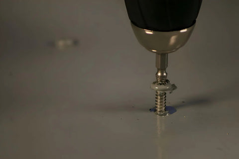 Close-up of Pro Grabit 8430P Two Step Drill Bit And Screw Extractor Kit removing stripped screw, showing self-centering tip in action.