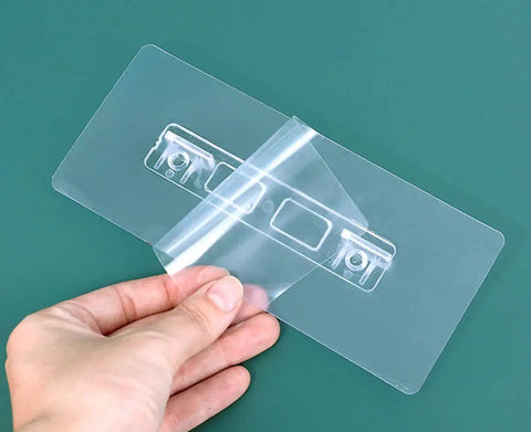 Hand peeling adhesive from transparent Self Adhesive Shelf Brackets Punch Free No Drill Shelf Supports Double Row Design Heavy Duty Clips