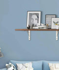 Rock Solid 2 Pack Triangle Shelf Brackets Crafted From Heavy Duty Stainless Steel Featuring A Slick Brushed Silver Finish and Integrated Mounting Holes for Effortless Wall Mount Storage and Nifty Garage Organization with decorative shelf and books.