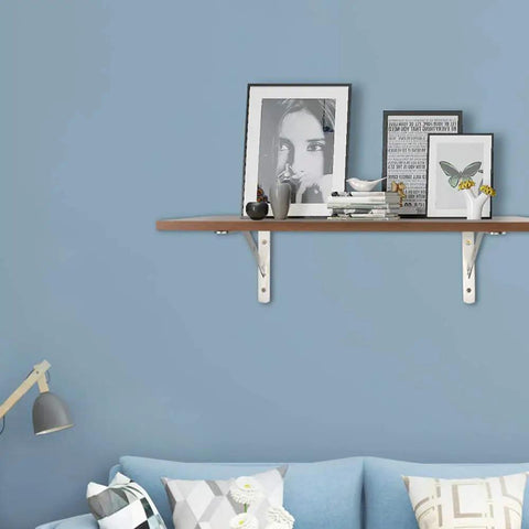 Rock Solid 2 Pack Triangle Shelf Brackets Crafted From Heavy Duty Stainless Steel Featuring A Slick Brushed Silver Finish and Integrated Mounting Holes for Effortless Wall Mount Storage and Nifty Garage Organization with decorative shelf and books.