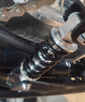 Close-up of 215mm universal rear shock absorber on bike fitting dirt bikes, ATVs for a bump-free ride on rough trails