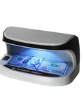 Counterfeit Money Detector With UV LED Light, handheld bill checker in use, detecting fake currency with blue UV light on banknote.