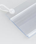 Close-up of clear 100 Pack Plastic Wire Shelf Label Holders 4 By 2.3 Inches with double snap lock closure for retail and pantry use.