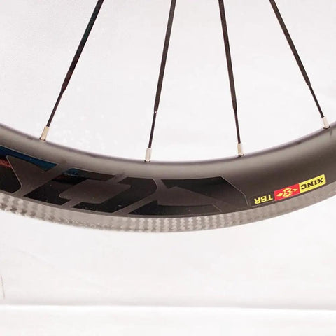 Close-up of Carbon Fiber 700C Road Bike Wheel Set With 50mm Clincher Rim, showing the sleek carbon material and spoke design.