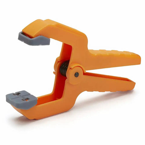 Mini 1 Inch Spring Clamp Set Of 20 Durable Polymer Clamps For Tight Spaces With Pivoting Pads, single orange clamp displayed.
