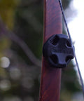 Close-up of a Low-Profile Recurve Dampener Kit For Recurve And Youth Solid Limb Compound Bows attached to a bow limb.