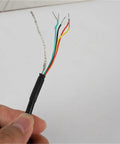 Hand holding exposed wires of Rotary Encoder TRD-GK1000-RZ 600 360 1024 2000 Incremental Encoder for Precision Motion Control.