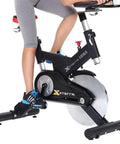 Person using exercise bike with Universal Bicycle Pedal Straps One Pair Replacement Foot Straps For Bikes Or Exercise Bike Spin Class Sixteen Inch Length Durable Nylon Wear Resistant Replaces Missing Or Broken Straps On Outdoor Bikes And Home Trainers.
