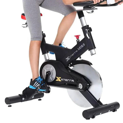 Person using exercise bike with Universal Bicycle Pedal Straps One Pair Replacement Foot Straps For Bikes Or Exercise Bike Spin Class Sixteen Inch Length Durable Nylon Wear Resistant Replaces Missing Or Broken Straps On Outdoor Bikes And Home Trainers.