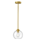 Brass and glass pendant light on white background with visible bulb, modern design