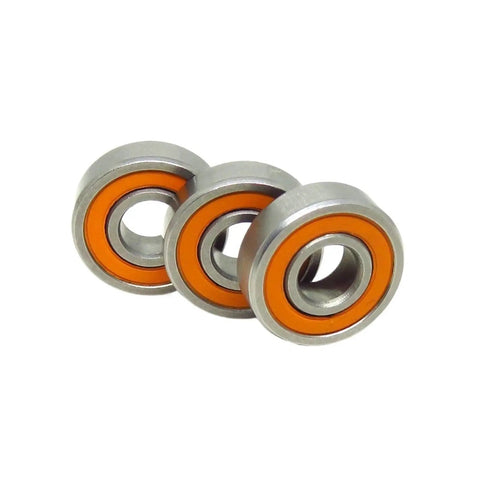 Close-up of three orange stainless steel bearings from 10 Pack 5x13x4 S695C Hybrid Ceramic Bearing ABEC 7 2RS RS For RC Cars.