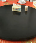 Multi Color Wooden Lazy Susan Round Rotating Serving Tray A Smooth Operator For Dining Tables And Kitchen Counters A Real Deal Hosting Game Changer With Easy Spin Action In Black on a dining table with condiments.