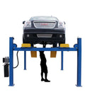 Commercial 4 Post Vehicle Alignment Lift With Heavy Duty Rotating Platforms And Secure Grip Flooring Designed For Daily Shop Use lifting a GMC SUV.