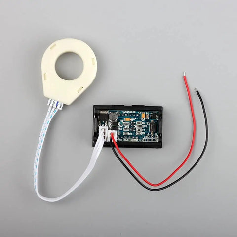 Premium Top Shelf Heavy Duty DC Volt And Amp Meter With Hall Effect Sensor showing circuit board and clamp sensor.