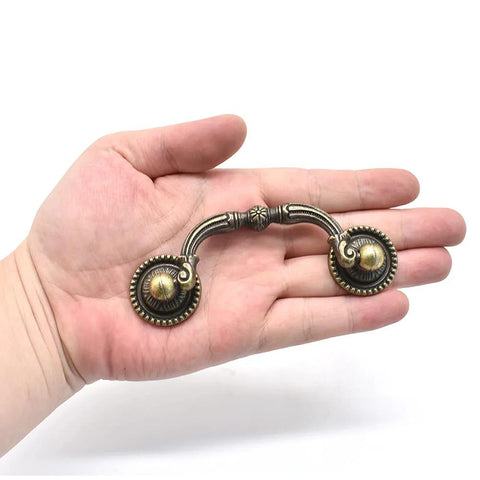 2 Pack Antique Drawer Pulls in Vintage Bronze Finish with 3 Inch Center Hole Spacing Rustic Zinc Alloy Cabinet Handles held in hand