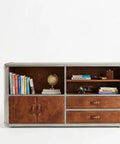 Knockout Aviator Sideboard Cabinet Drops That Aero Industrial Heat With Wraparound Weathered Brown Leather Riveted Silver Trim And Massive Storage Building A Solid 54 Inch Credenza Console Table For Any Cool Living Space with books and globe.