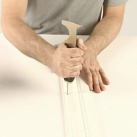Person using Six In One Painter Tool For DIYers With Scraper, Putty Knife, Roller Cleaner, Nail Setter, Gouger And Spreader on trim