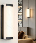 Tipace Hardwired Modern Black LED Wall Sconce Indoor Wall Light Fixture mounted on a wall with a soft glow.