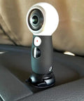 Quick Release Flat And Curved Surface Camera Mount With Strong Adhesive Base holds a camera on a dashboard surface.